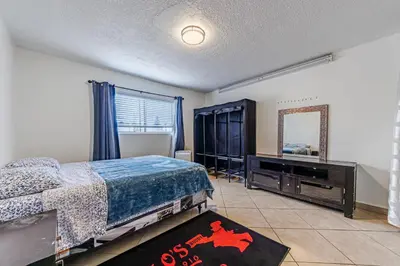 a bedroom with a bed and a dresser and a mirror at Amazing Berryman 1bd#8 in Los Angeles