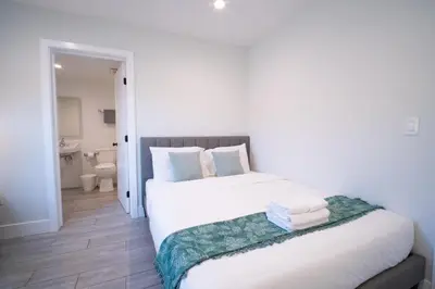 a bedroom with a bed and a bathroom at Stylish Private Ensuite Room near USC in Los Angeles
