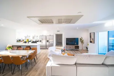 a living room with a couch and a table at Modern Private Ensuite Room near USC in Los Angeles