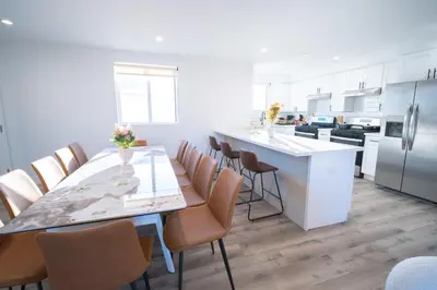 a kitchen with a long dining table and chairs at Modern Private Ensuite Room near USC in Los Angeles