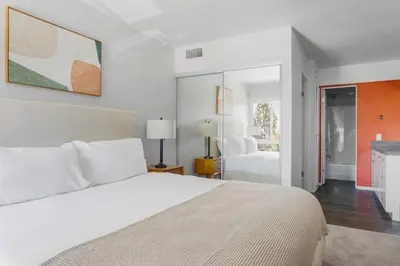 a bedroom with a large white bed and a fireplace at Blueground Hollywood Hills jacuzzi nr Runyon Canyon LAX-1380 in Los Angeles