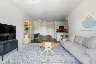 a living room with a couch and a table at Blueground Hollywood Hills jacuzzi nr Runyon Canyon LAX-1380 in Los Angeles