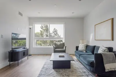 a living room with a couch and a table at Blueground Sawtelle rooftop nr Culver City Park LAX-1373 in Los Angeles