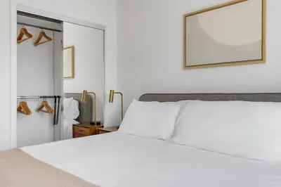 a bedroom with a white bed and a mirror at Blueground Sawtelle rooftop nr Culver City Park LAX-1373 in Los Angeles