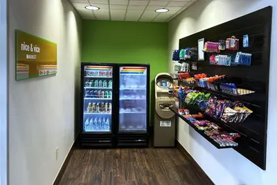 a grocery store aisle with a refrigerator and drinks at Wyndham Garden Lancaster CA in Lancaster