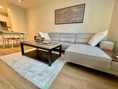 a living room with a couch and a coffee table at Miracle Mile Apartments in Los Angeles