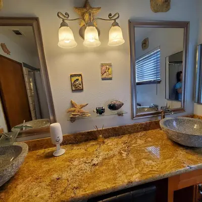 a bathroom with two sinks and a large mirror at Star Gazer's Paradise in Apple Valley