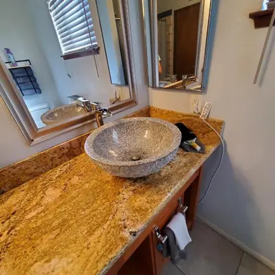 a bathroom sink with a granite counter top at Star Gazer's Paradise in Apple Valley