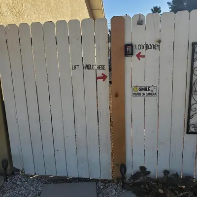 a white fence in front of a building at Star Gazer's Paradise in Apple Valley