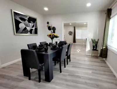 a dining room with a black table and chairs at Prime location King Bed! Private house1 in Alhambra