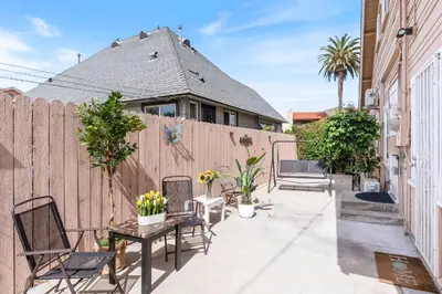 a patio with chairs and a wooden fence at Prime location King Bed! Private house1 in Alhambra
