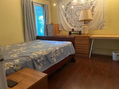 a bedroom with a bed and a desk and a window at \u6e29\u99a8\u5c0f\u5c4b in Ontario