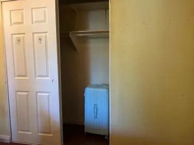 a hallway with a closet with a heater and a door at \u6e29\u99a8\u5c0f\u5c4b in Ontario