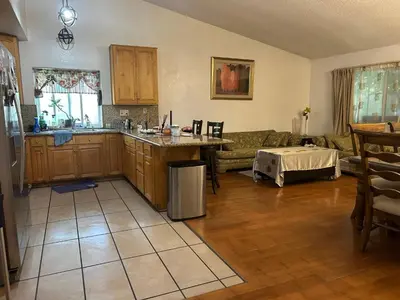 a kitchen and living room with a couch and a table at \u6e29\u99a8\u5c0f\u5c4b in Ontario