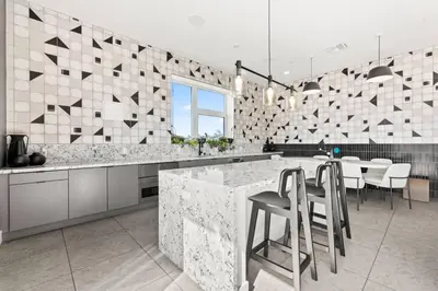 a kitchen with a large marble counter and chairs at Skyline Haven Near Dodger Stadium with Views in Los Angeles