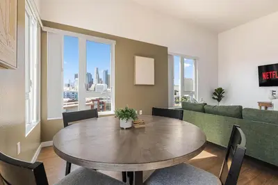 a living room with a table and a couch at Arts District Stay, Walk to Little Tokyo with Parking in Los Angeles