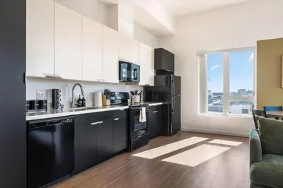 a kitchen with black and white appliances and a window at Arts District Stay, Walk to Little Tokyo with Parking in Los Angeles
