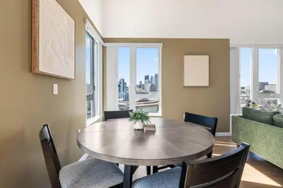 a dining room with a table and chairs and a couch at Arts District Stay, Walk to Little Tokyo with Parking in Los Angeles
