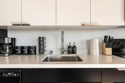 a kitchen with a sink and a microwave at Arts District Stay, Walk to Little Tokyo with Parking in Los Angeles