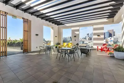 a patio with tables and chairs and windows at Arts District Stay, Walk to Little Tokyo with Parking in Los Angeles