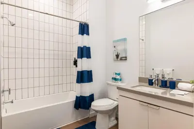 a bathroom with a toilet and a tub and a sink at Modern Studio Retreat in the Heart of Art District in Los Angeles