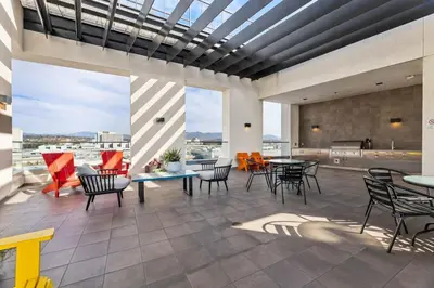 a patio with tables and chairs on a building at Arts District Condo, Walk to Little Tokyo Plaza in Los Angeles