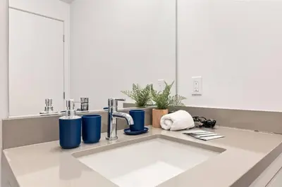a kitchen counter with a sink and a mirror at Arts District Condo, Walk to Little Tokyo Plaza in Los Angeles