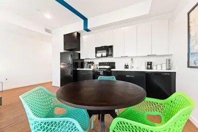 a kitchen with a table and chairs in a room at Chic Studio with Stunning DTLA Views, Walk to Metro in Los Angeles