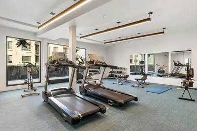 a gym with treadmills and ellipticals in a building at Spacious 1-BD with Stunning City Views in DTLA in Los Angeles