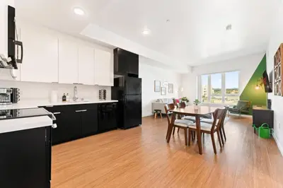 a kitchen and dining room with a table and chairs at Spacious 1-Bedroom Gem with Downtown LA Views in Los Angeles