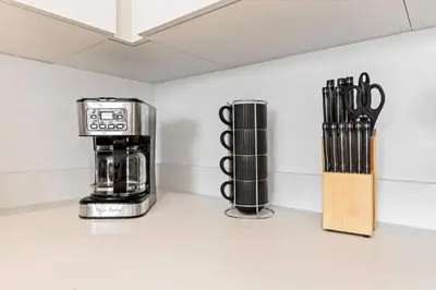 a kitchen counter with a coffee maker and utensils at Unique 1-Bedroom DTLA Escape with City Views in Los Angeles