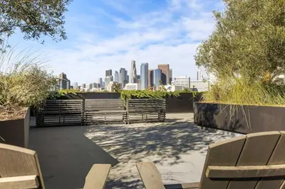 a patio with benches and a city skyline at Unique 1-Bedroom DTLA Escape with City Views in Los Angeles