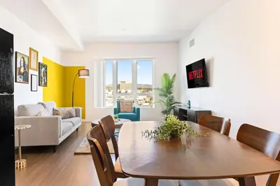 a living room with a table and a couch at Designer Stay in Arts District, Walk to Little Tokyo in Los Angeles