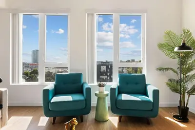 two blue chairs in a room with windows at Chic and Cozy Home, Walk to Little Tokyo with Parking in Los Angeles