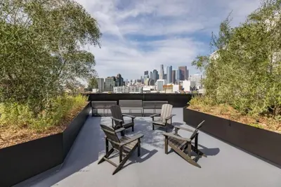 a balcony with chairs and a view of the city at Chic and Cozy Home, Walk to Little Tokyo with Parking in Los Angeles