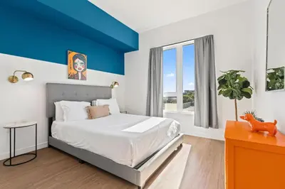 a bedroom with a bed with a blue accent wall at Little Tokyo Gem, Steps from Shops with Free Parking in Los Angeles