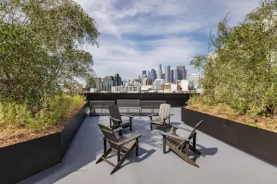 a patio with chairs and tables on top of a building at Little Tokyo Gem, Steps from Shops with Free Parking in Los Angeles