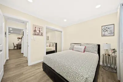 a white bedroom with a bed and a hallway at Vibrant & Refreshing - 12 min to Downtown LA in Alhambra