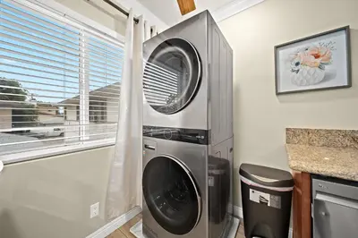 a washer and dryer in a kitchen with a window at Vibrant & Refreshing - 12 min to Downtown LA in Alhambra