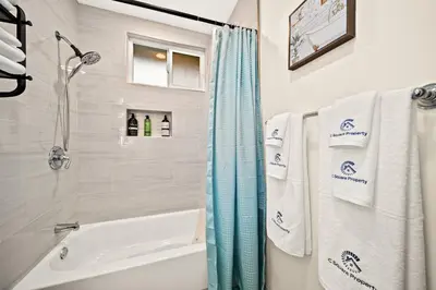 a bathroom with a tub and a shower with towels at Vibrant & Refreshing - 12 min to Downtown LA in Alhambra