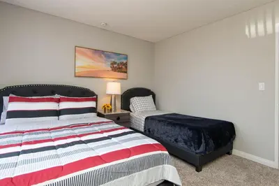 a bedroom with a bed and a bed sidx sidx sidx sidx at Modern Hollywood Apt Rooftop Pool & Skyline Views in Los Angeles