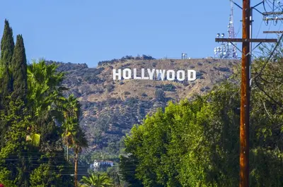 a hollywood sign on the side of a mountain at Modern Hollywood Apt Rooftop Pool & Skyline Views in Los Angeles