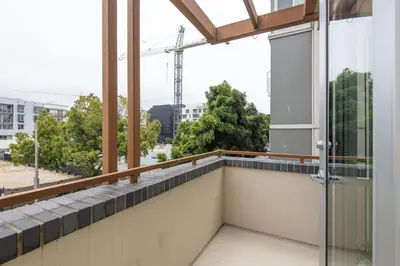 a balcony with a view of a building at Walk to Santa Monica Beach Pier Boardwalk Venice in Los Angeles