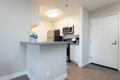 a kitchen with white cabinets and a counter top at Stylish 2BR Apt with Rooftop Pool & Hollywood Views in Los Angeles