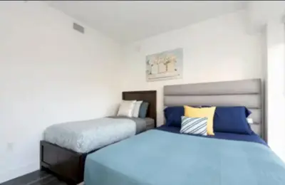 two beds sitting next to each other in a bedroom at Cozy 2bd Apt Near Disneyland Anaheim Conv Center in Anaheim