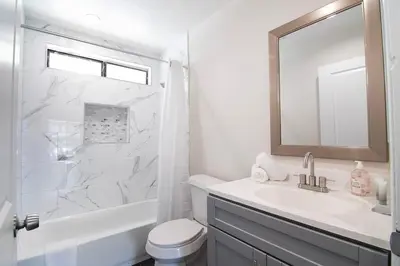 a white bathroom with a sink and a mirror at Stylish 1BR Near Universal Studios with Parking in Los Angeles