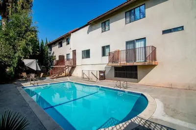 a large swimming pool in front of a building at Stylish 1BR Near Universal Studios with Parking in Los Angeles