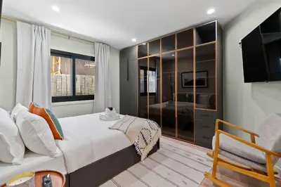 a bedroom with a large bed and a television at New Listing Marina Villa by Colby & Conrad in Los Angeles