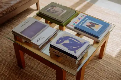 a coffee table with books on top of it at Mane & Saddle Loft in Los Angeles