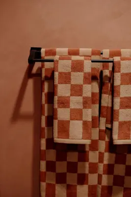 a checkered towel is hanging on a towel rack at Mane & Saddle Loft in Los Angeles